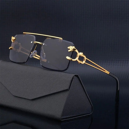 Gold-framed sunglasses with black lenses on a dark background